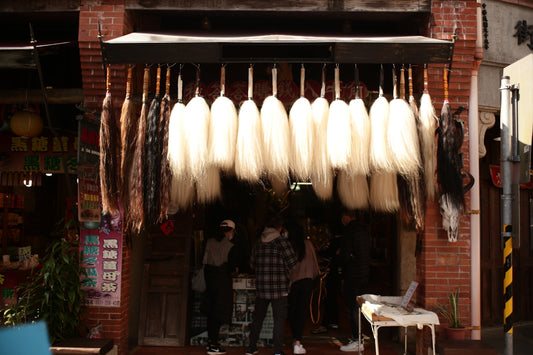 people standing near brown wooden table during daytime