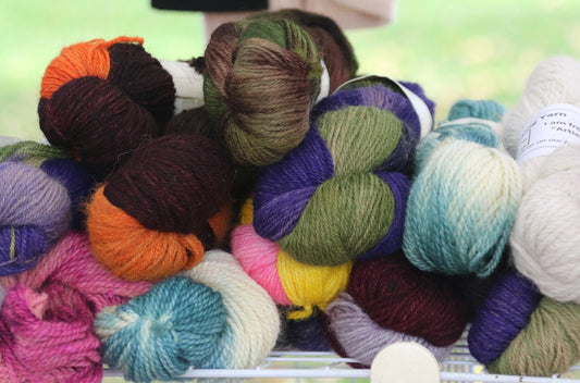 a pile of skeins of yarn sitting on top of a table